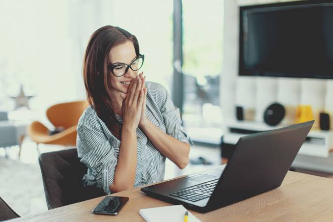 Happy business owner working on laptop